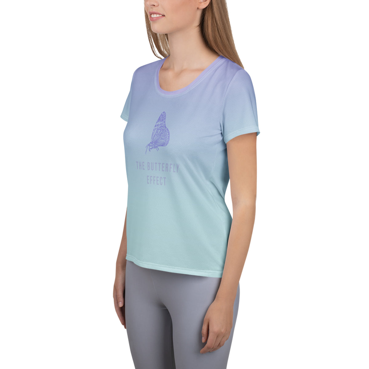 A woman wearing a light blue and mint green gradient short-sleeve t-shirt with a purple butterfly graphic and the text 'THE BUTTERFLY EFFECT' on the front, paired with gray leggings, set against a plain white background.