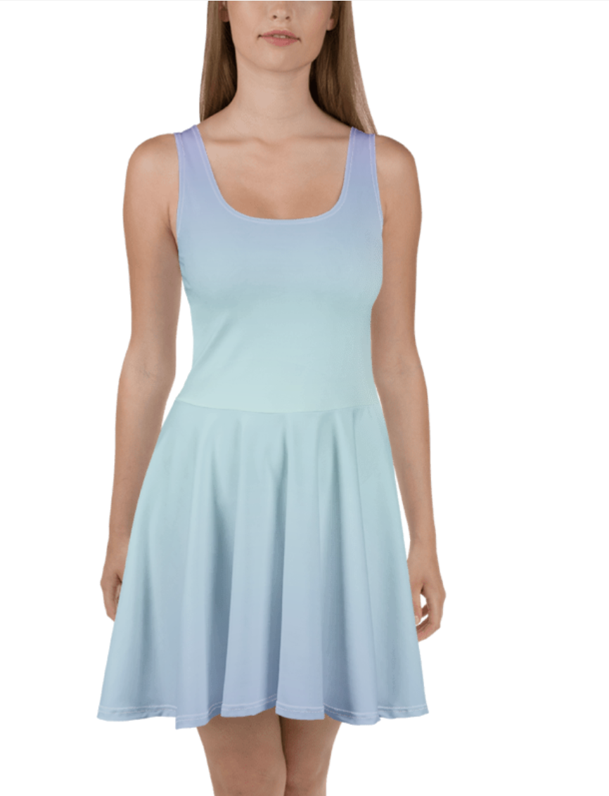 A woman modeling a sleeveless scoop-neck skater dress in a very light pastel blue, shown against a plain white background.