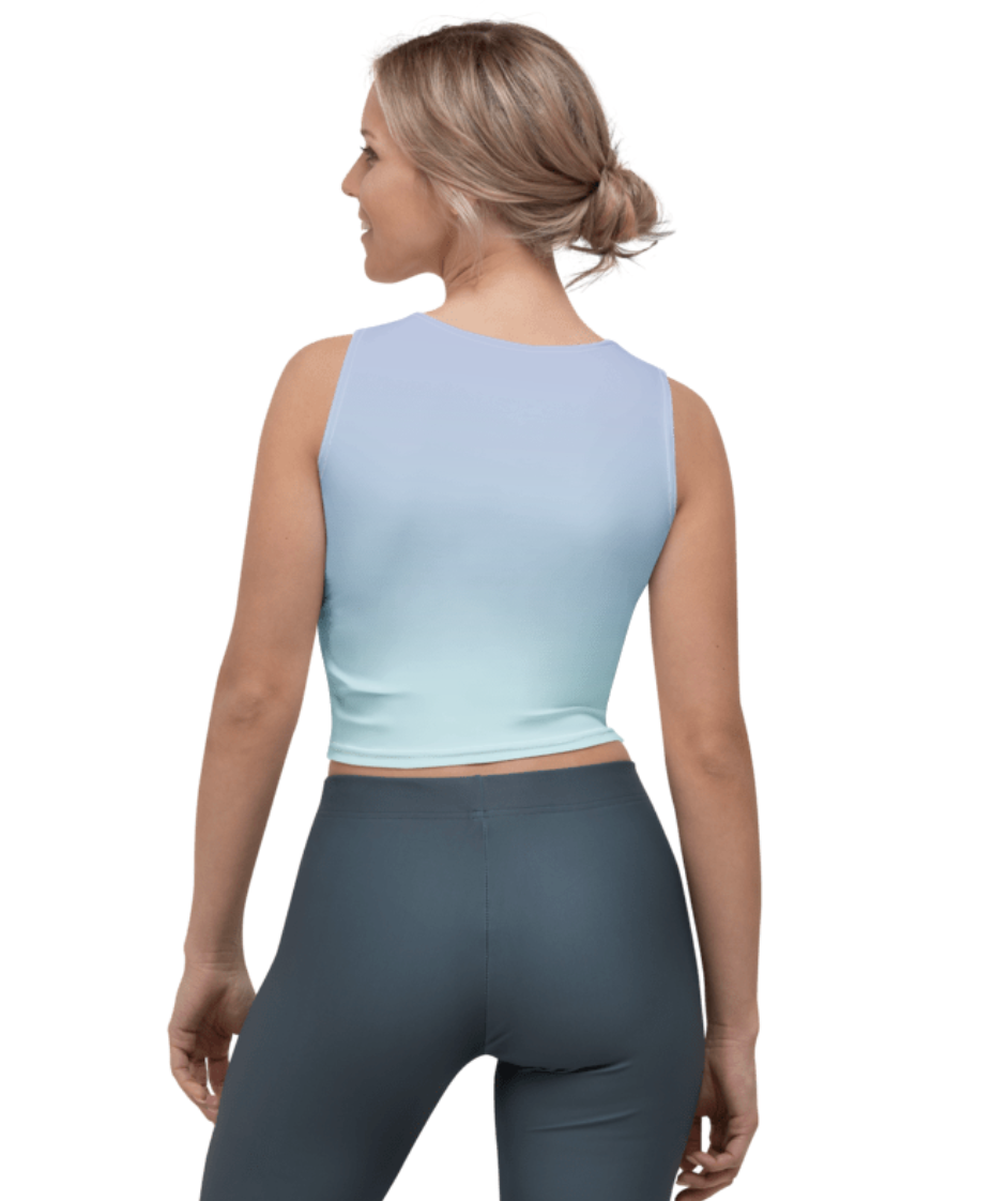 A woman shown from the back wearing a sleeveless light blue crop top and dark gray leggings against a plain white background.
