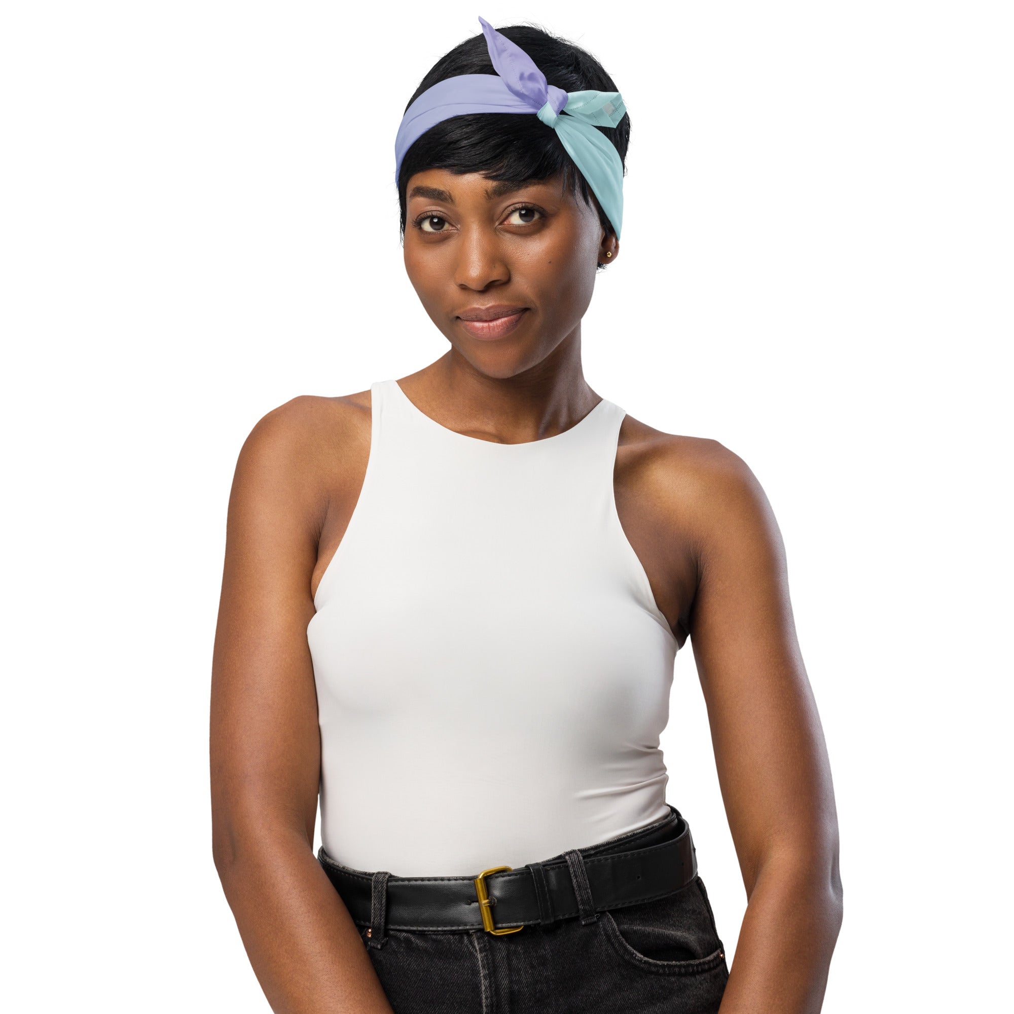 Woman wearing a white tank top and black pants with a colorful headband on a white background