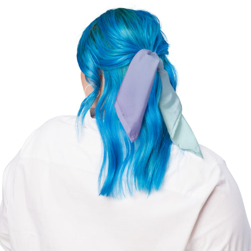 A person shown from the back wearing a white top, with bright blue hair and a lavender satin hair tie or scarf tied around the hair against a plain white background.