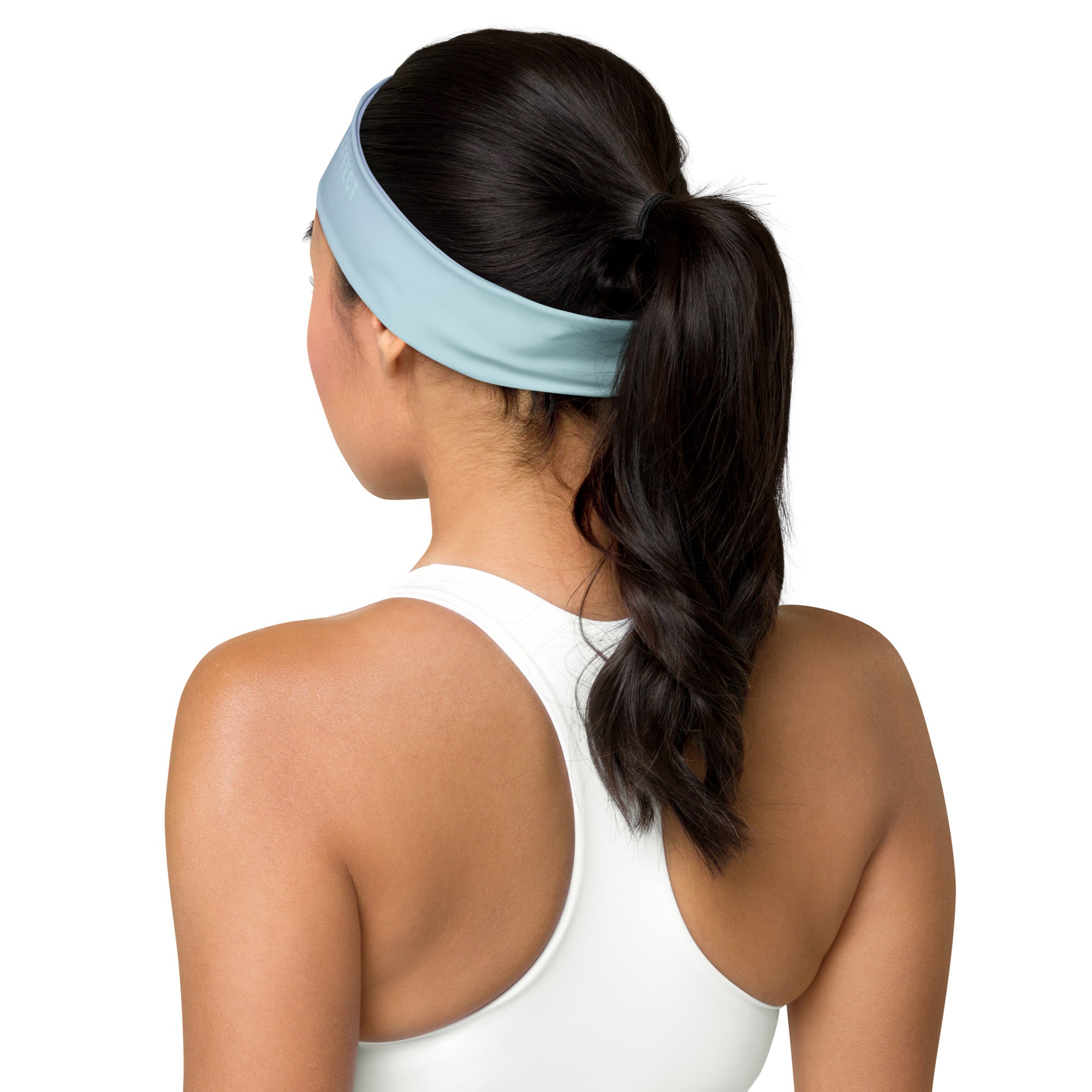 A woman shown from the back wearing a light blue athletic headband with her hair in a ponytail, against a plain white background.