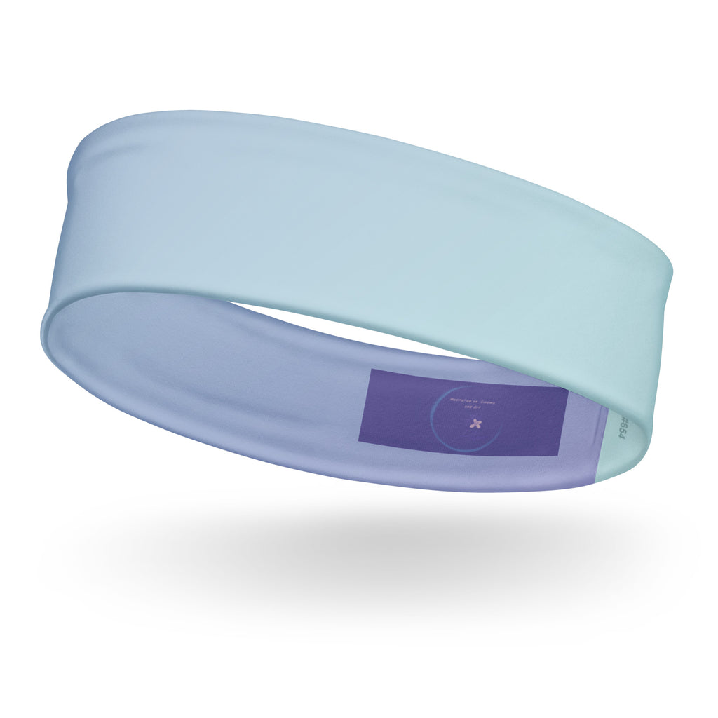A light blue athletic headband floating on a white background with a soft shadow underneath. The inside of the headband features a purple label with a circular logo.