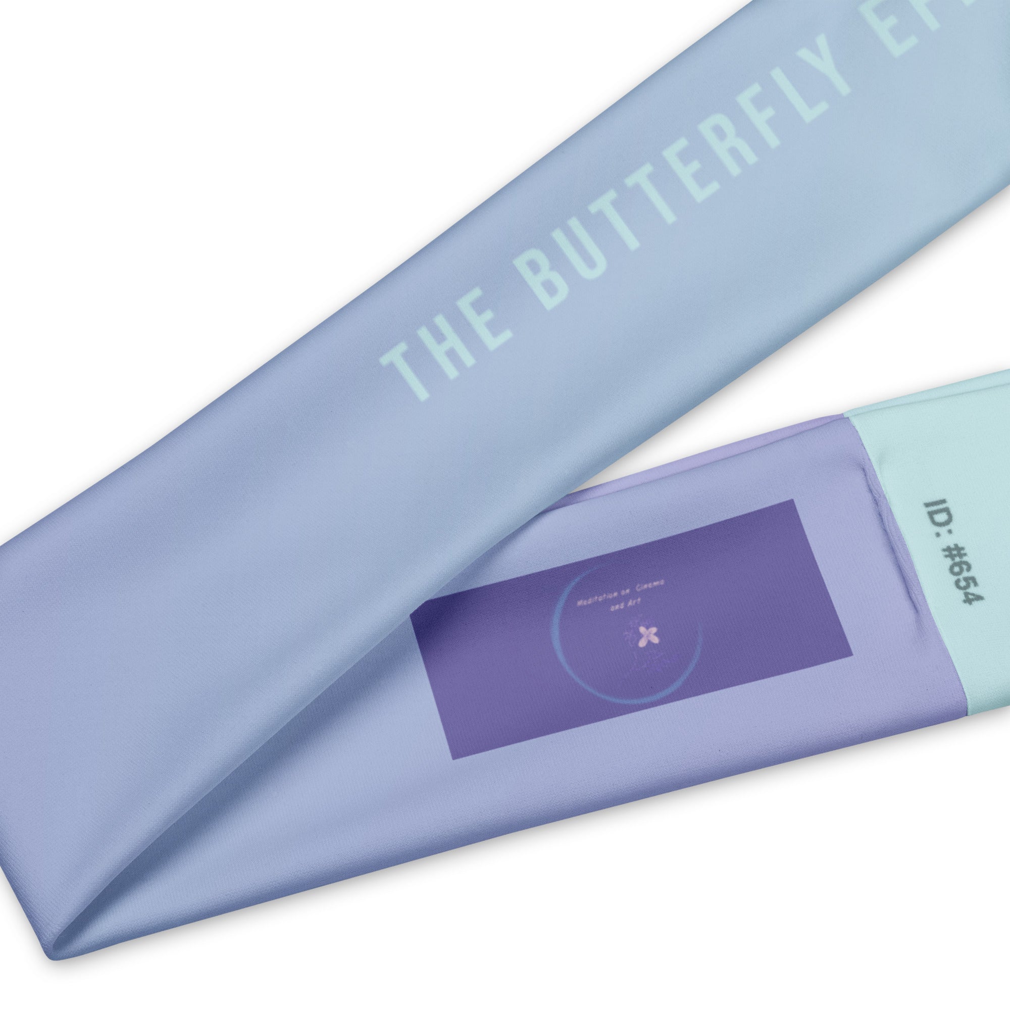 A close-up of a light blue fabric item printed with the words 'THE BUTTERFLY EP.