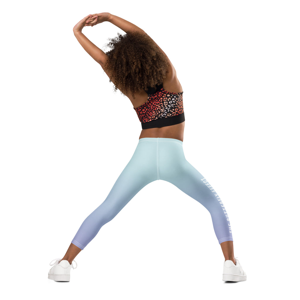 Person wearing a colorful sports bra and gradient leggings on a white background