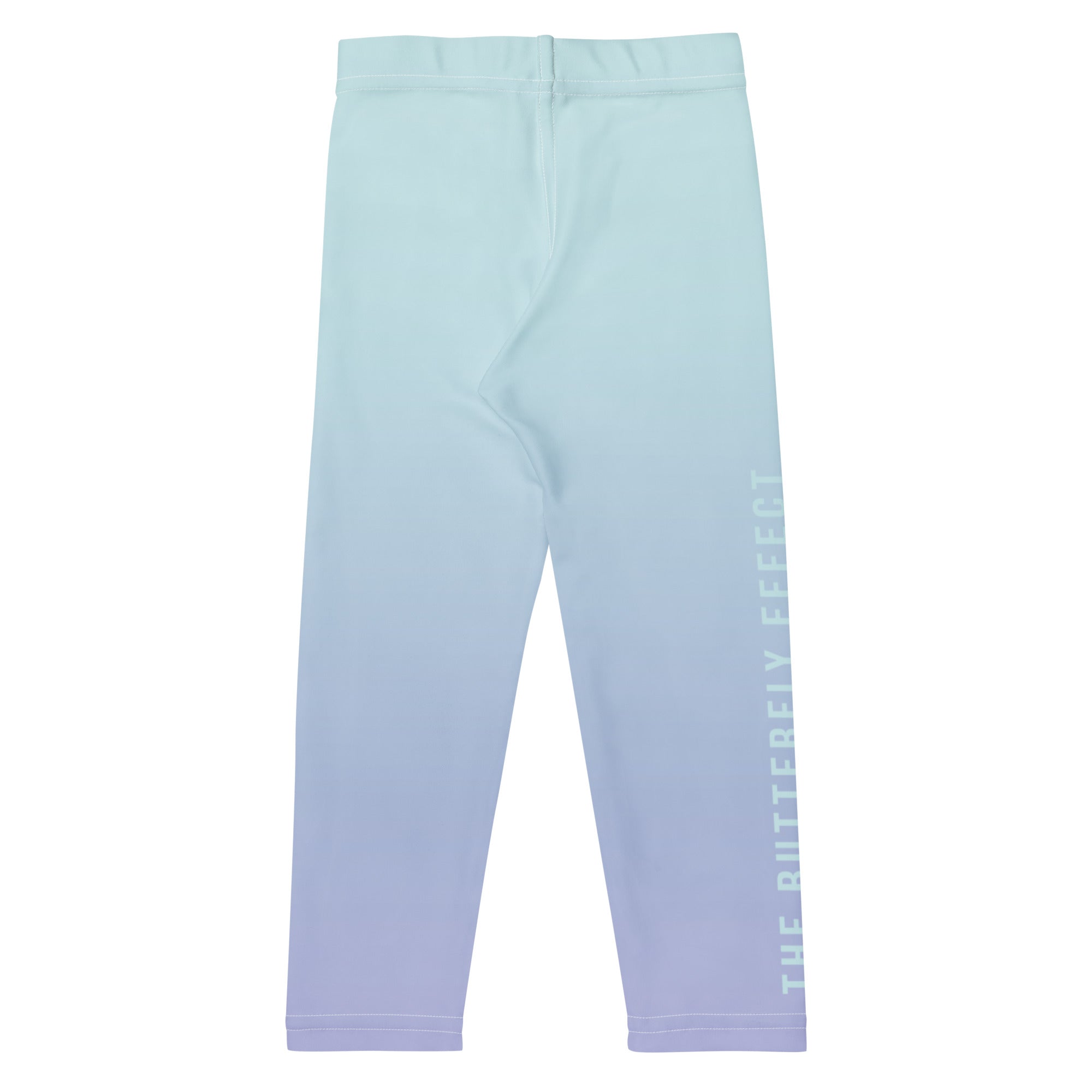 A pair of children's leggings with a vertical ombre gradient transitioning from light mint green at the top to soft lavender at the bottom, featuring 'THE BUTTERFLY EFFECT' printed vertically in white on the lower right leg.