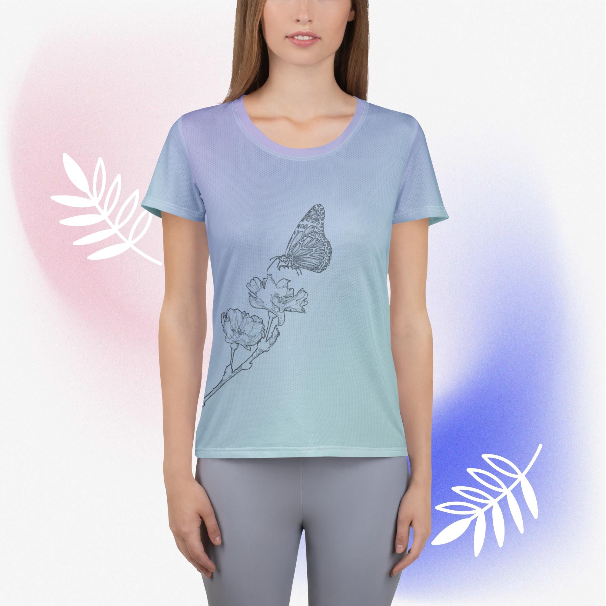 A woman modeling a short-sleeve athletic T-shirt with a smooth blue-to-green gradient and a butterfly-and-flower line drawing on the front, paired with gray leggings against a soft pastel studio background with white leaf graphics.