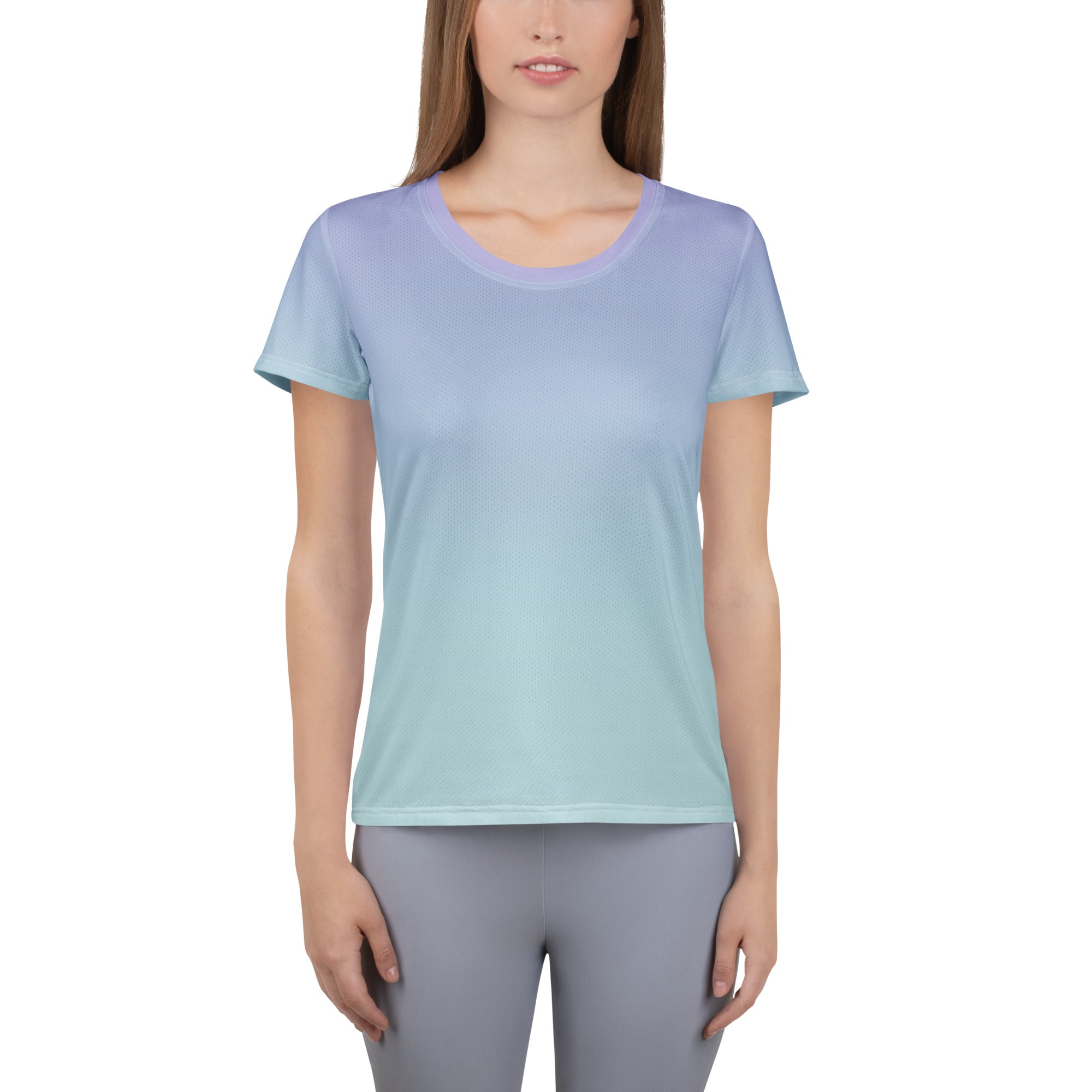 A woman modeling a short-sleeve crewneck athletic t-shirt with a smooth vertical color gradient transitioning from light lavender purple at the top to mint green at the bottom, paired with gray leggings against a plain white background.