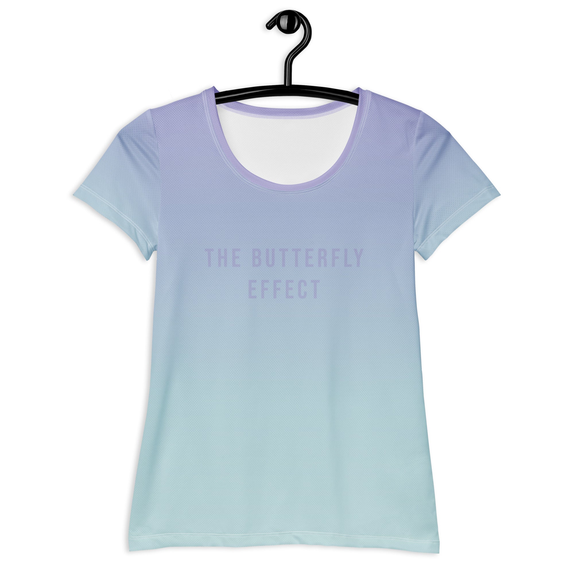 A short-sleeve scoop-neck t-shirt hanging on a black hanger against a white background, featuring a smooth vertical gradient from light lavender purple at the top to pale icy blue at the bottom, with the text 'THE BUTTERFLY EFFECT' printed in a matching light purple font on the chest.