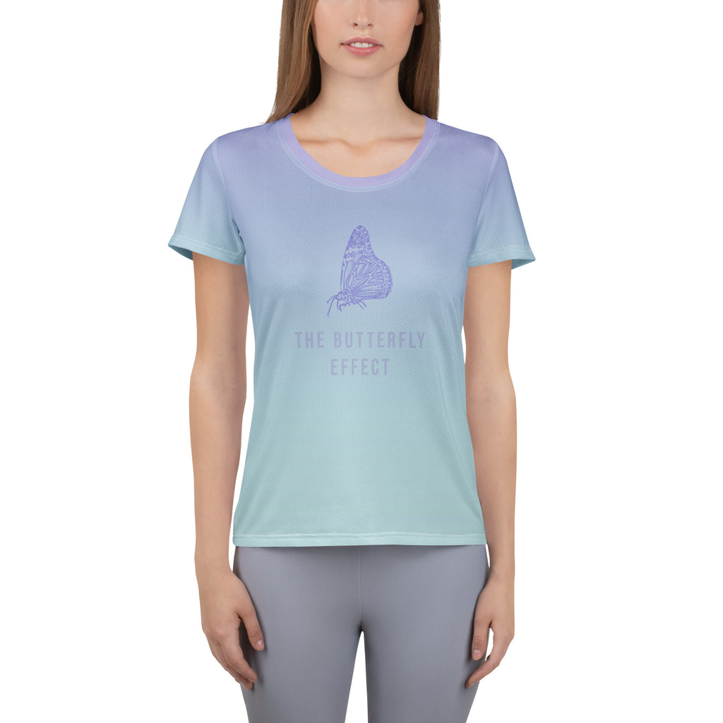 A woman modeling a short-sleeve crewneck t-shirt with a smooth light blue to lavender-purple gradient. The center of the shirt features a purple butterfly graphic with the text 'THE BUTTERFLY EFFECT' printed below it.