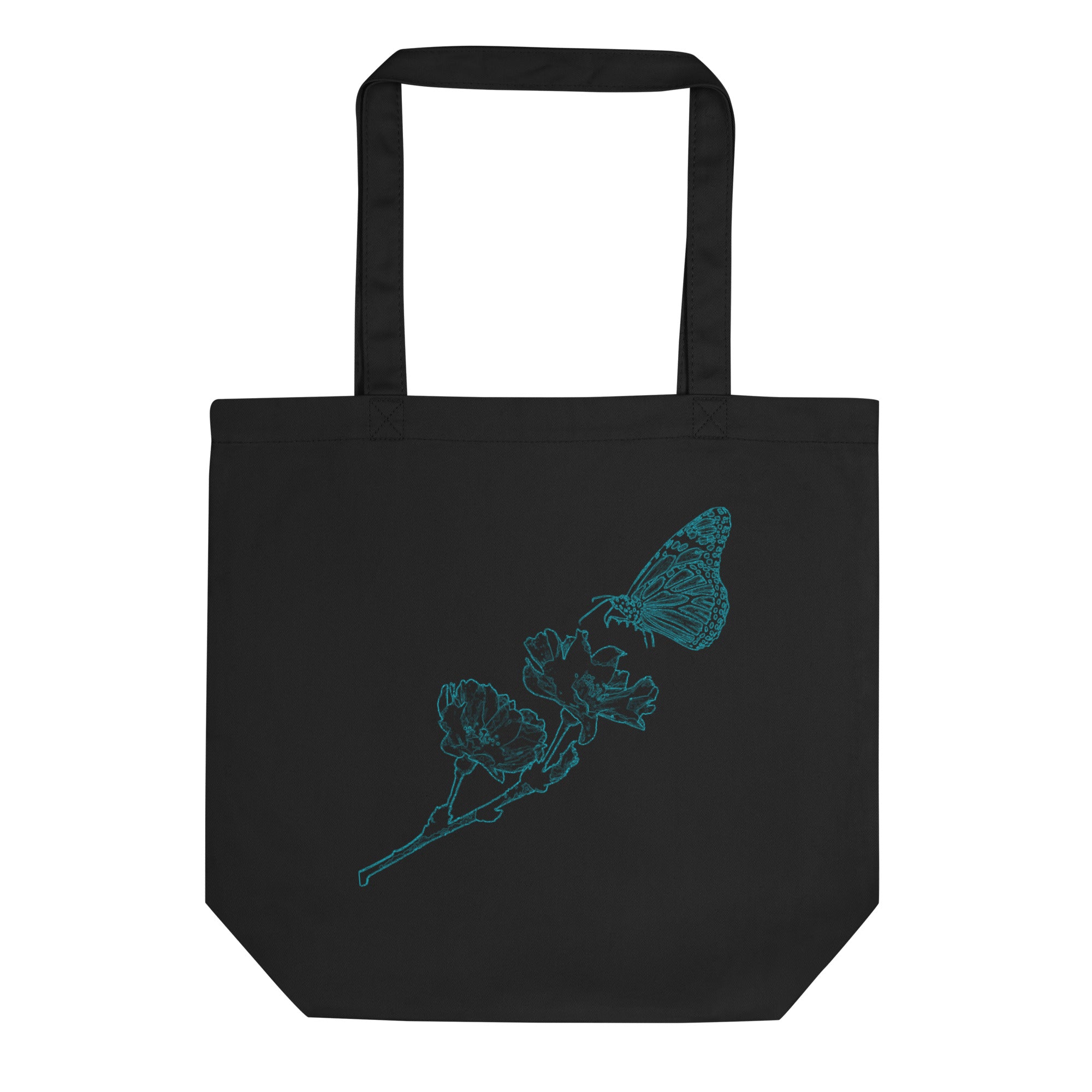 A black canvas tote bag with two black shoulder straps, featuring a teal line art graphic of a butterfly perched on a flower branch on the front, set against a plain white background.